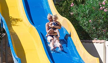 Woman with her baby at the arrival of a water slide at the campsite near Béziers
