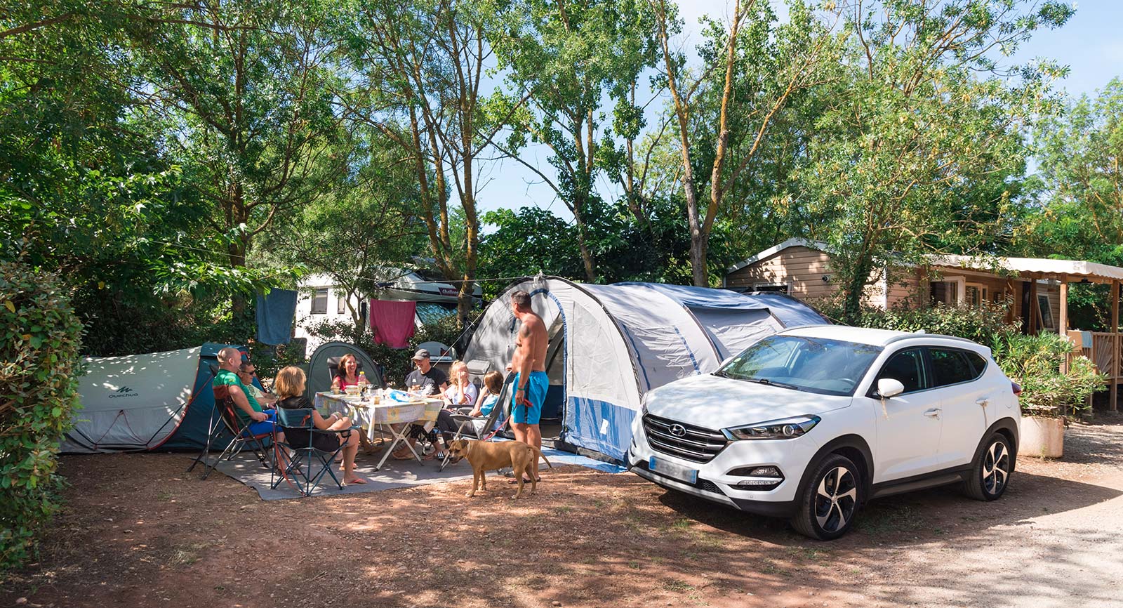 Car and tent on a campsite near Salagou