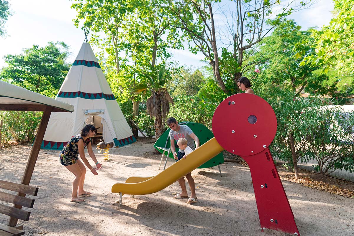 Slide and tepee on the playground of the campsite's children's club